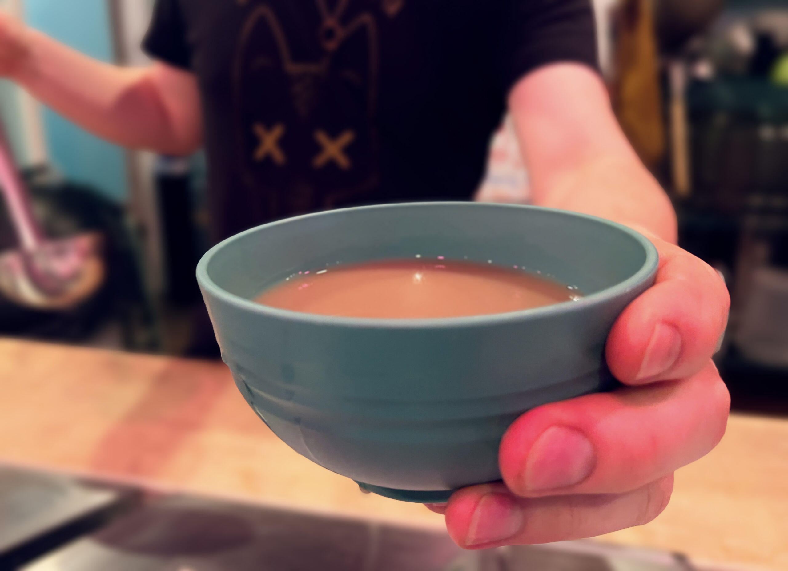 Kavatender pouring a shell of Kava at Denver's Favorite Kava Bar